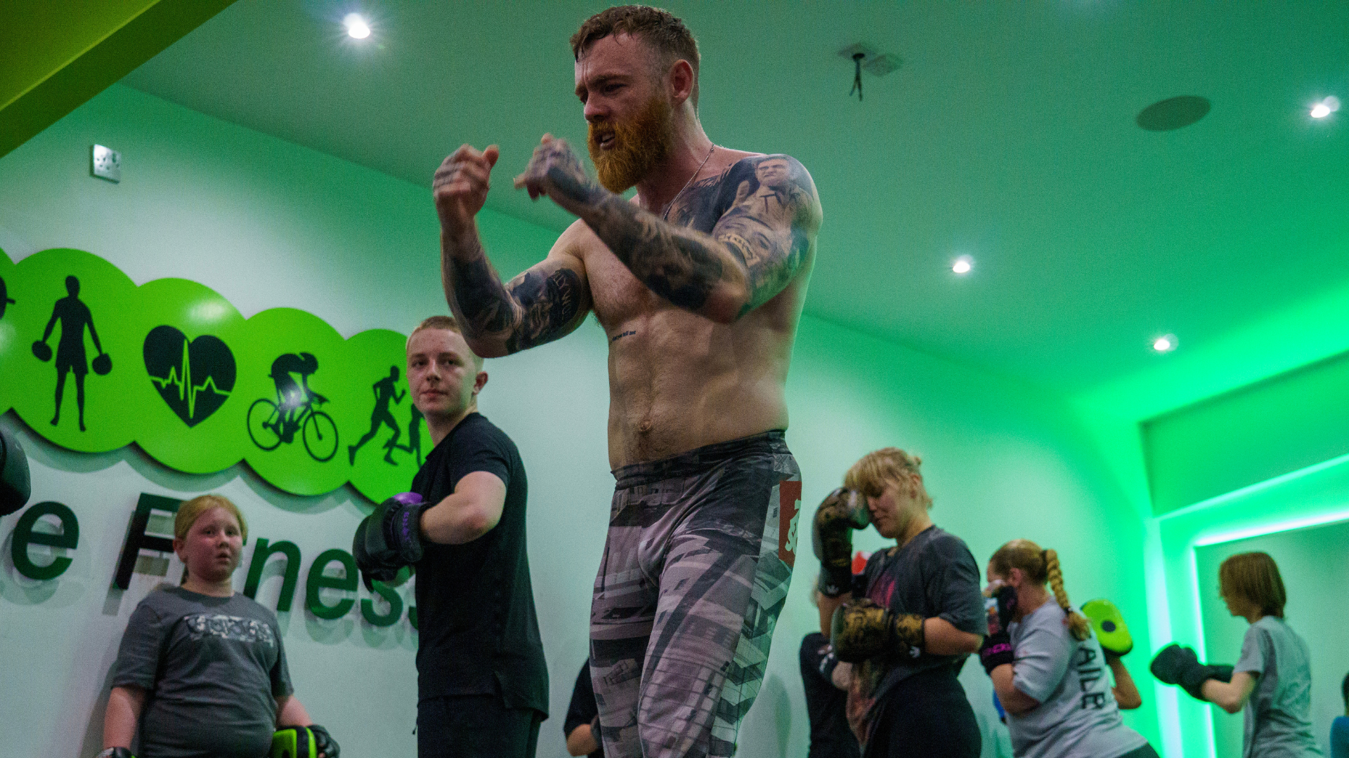 Jake Bingham coaching pad work in the gym