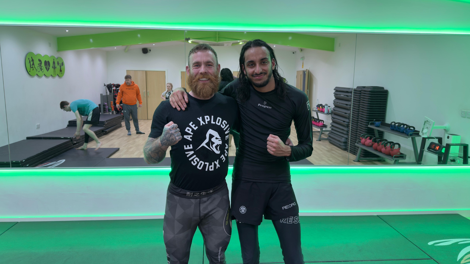 Jake Bingham on the gym floor with a training partner